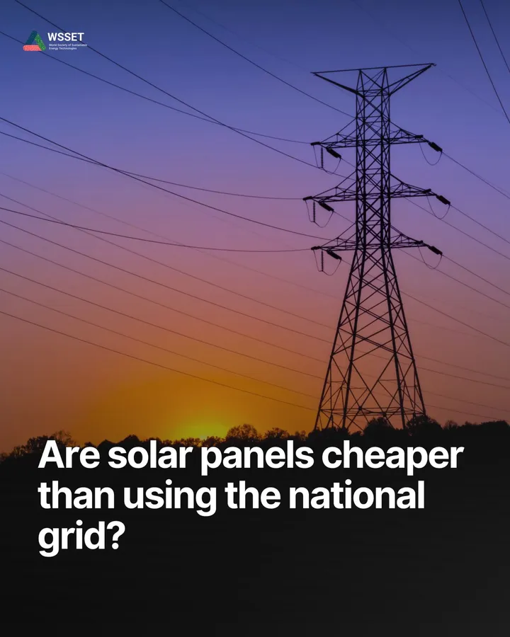 An electricity pylon silhouetted against an orange sunset